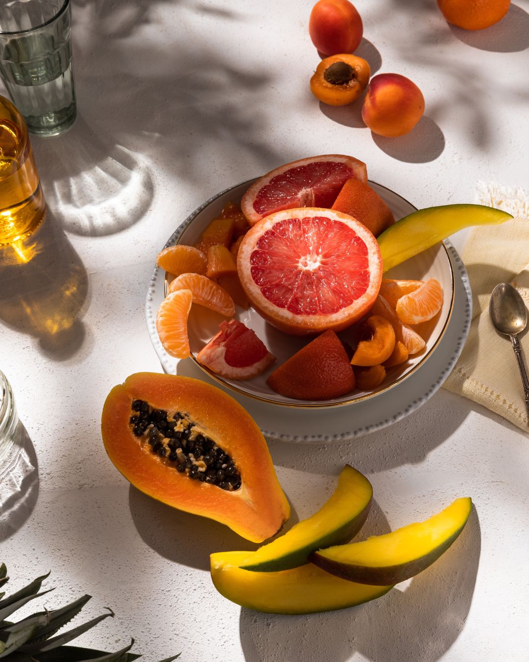grapefruit, papaya, orange, melon and apricot fruit platter photography